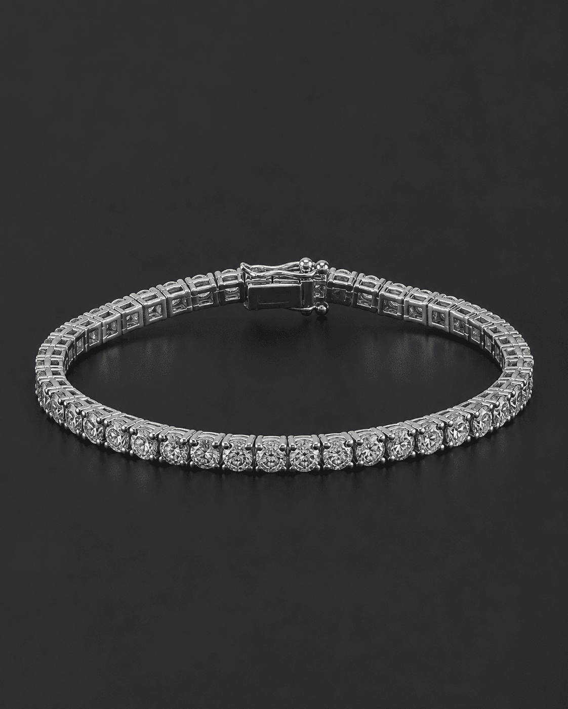 Diamond line bracelet forming a full loop, set in white metal, on a dark background