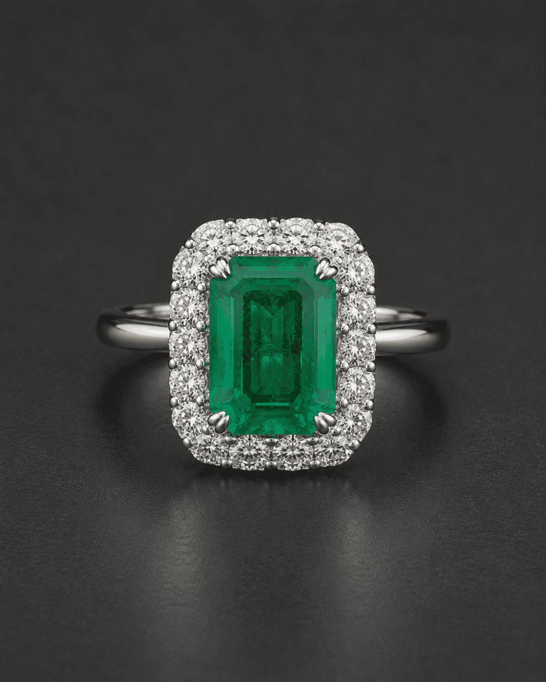Ring with a green emerald-cut gemstone framed by a diamond halo in white metal