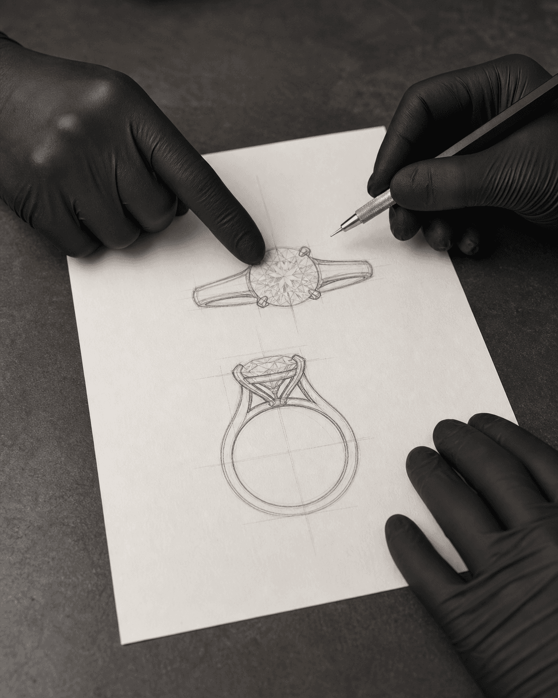 Gloved hands reviewing a pencil sketch of a diamond ring on a dark workbench, one hand pointing and another holding a technical pencil